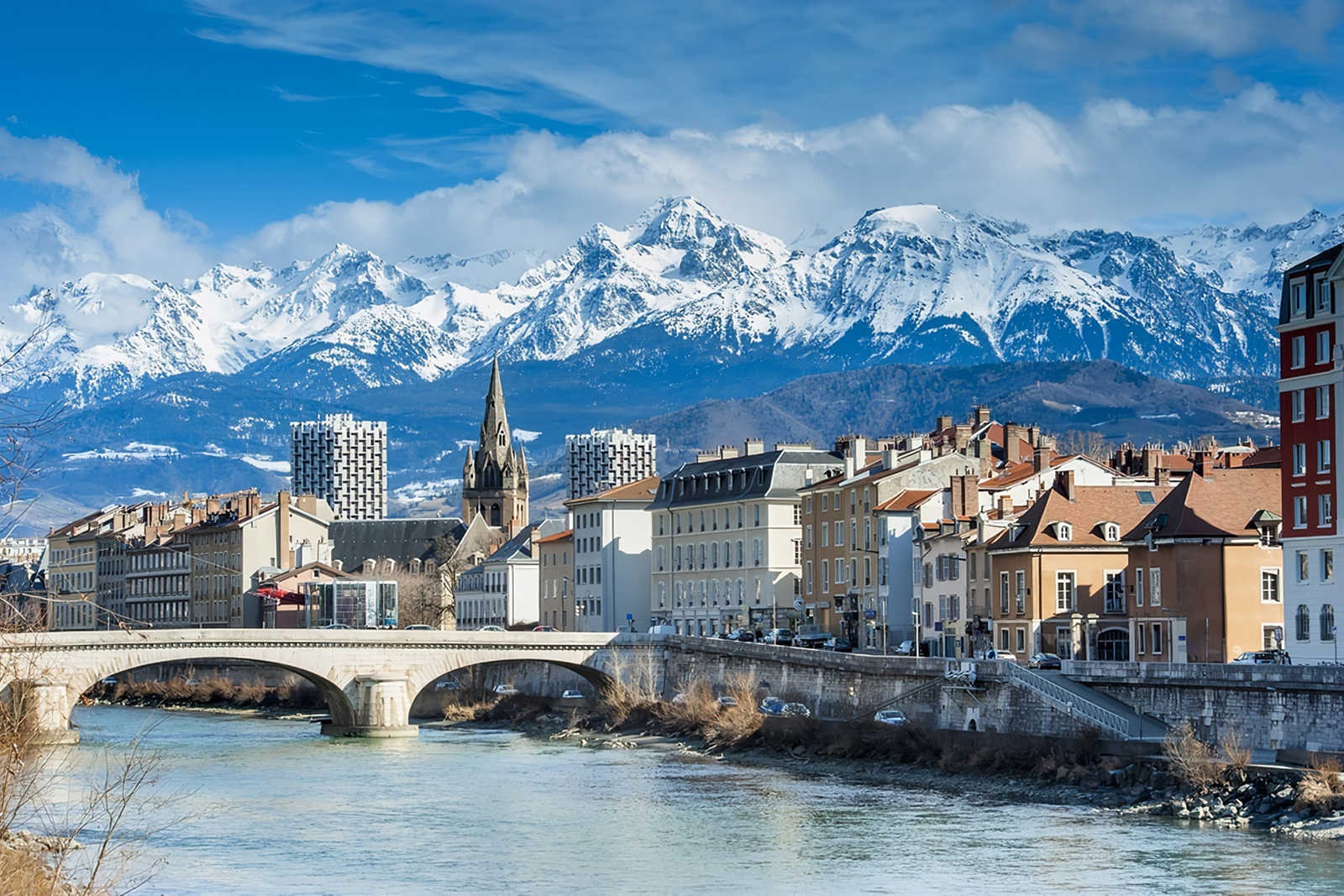 Downtown Grenoble, the Isère River, and the snow-capped Belledonne mountain range